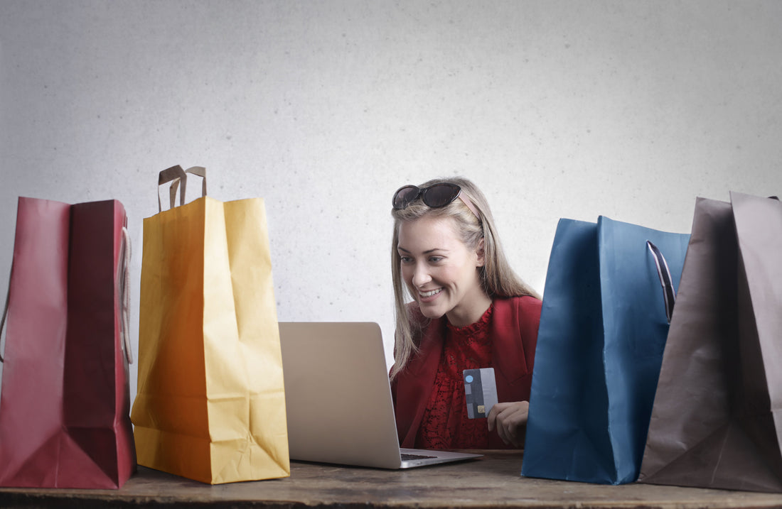 Shopify shopper browsing online with a credit card, representing the chance to win an order free through Win Back, Trusted Roll, or Playably.