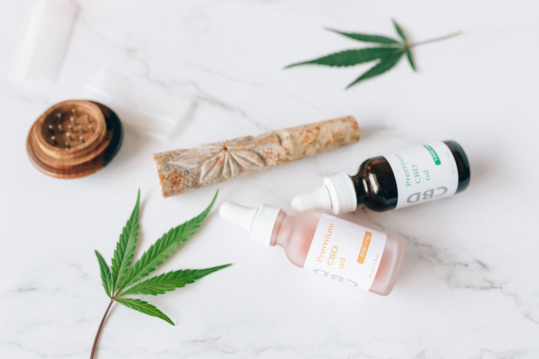 CBD oil dropper bottles and hemp leaves on a marble surface, for CBD brands that can’t run Meta ads
