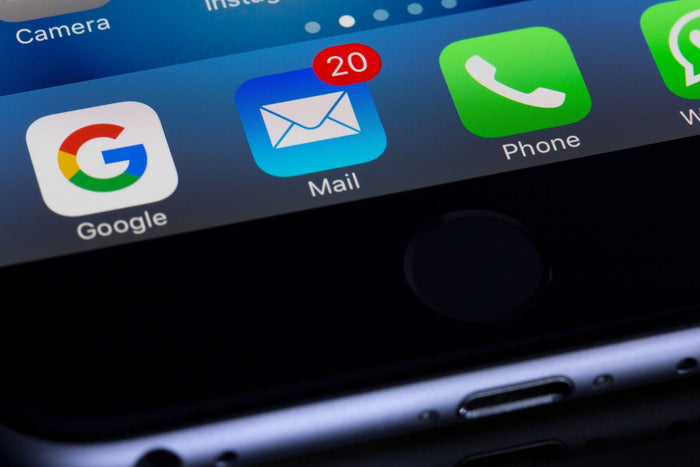 Smartphone home screen showing an email inbox app with unread notifications, illustrating gamified email capture for Shopify list growth