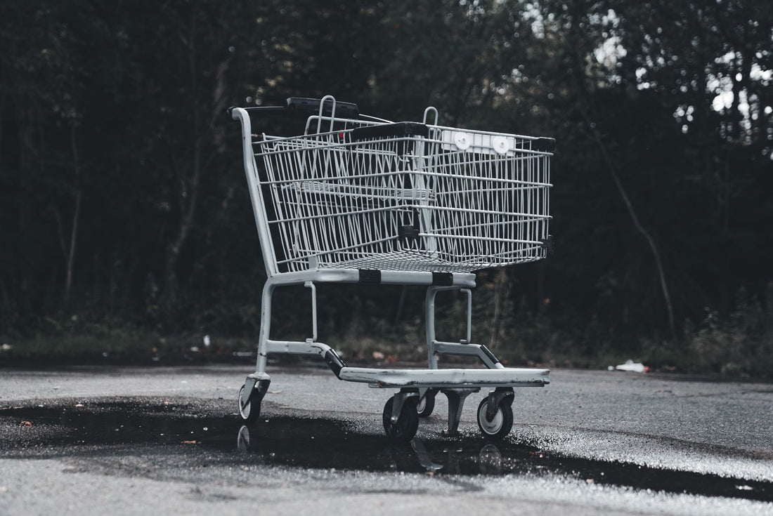 Empty shopping cart left in a deserted parking lot, illustrating abandoned cart recovery without discount codes