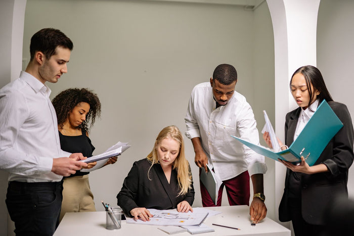 A team reviewing documents together while evaluating turnkey gamification programs for customer acquisition