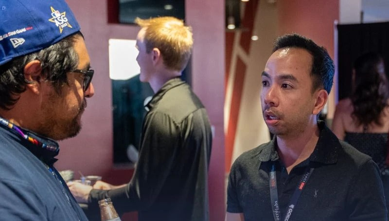 Playably team talking with a guest at an industry event